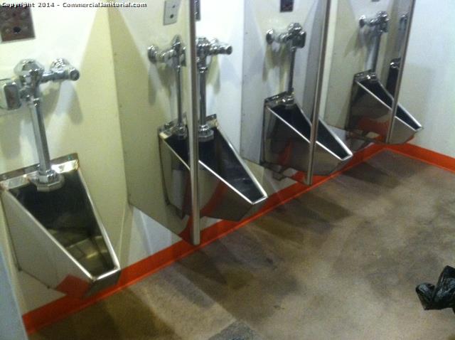4 stainless steel urinals that were cleaned in an office