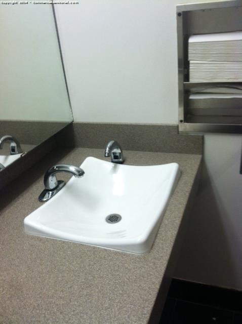 day porters clean sinks in an office