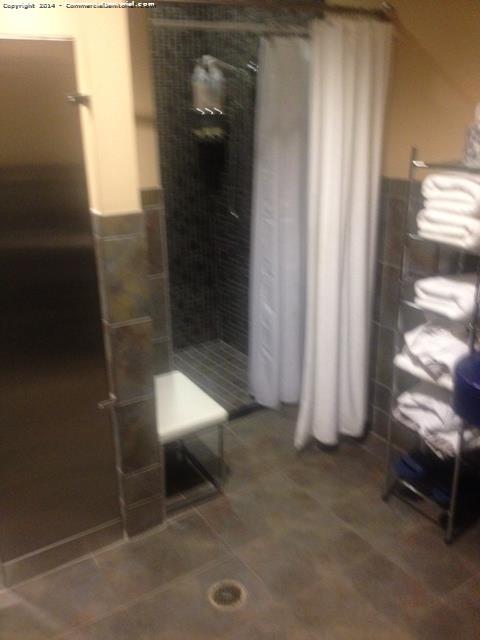 All showers were cleaned  , the towel rack was restocked , and floor was properly mopped . 