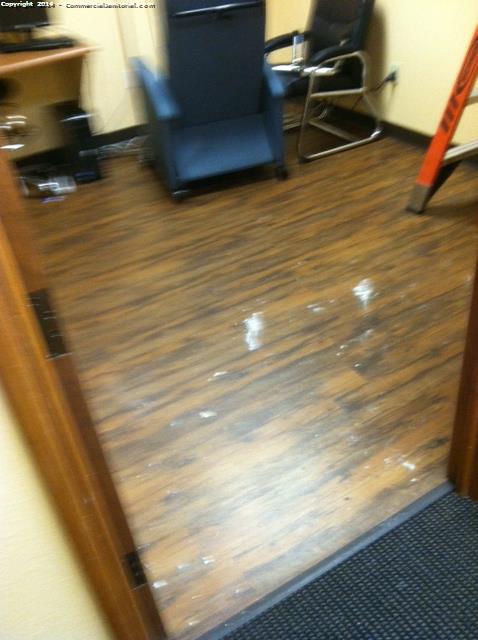 Janitors clean up debris in a medical office that is left by a construction company.