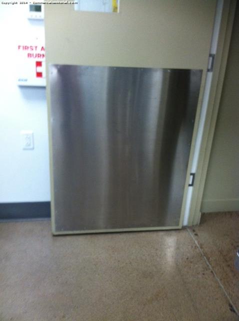 Wiping down all stainless steel at the bottom of the doors for shoe marks and scratches 