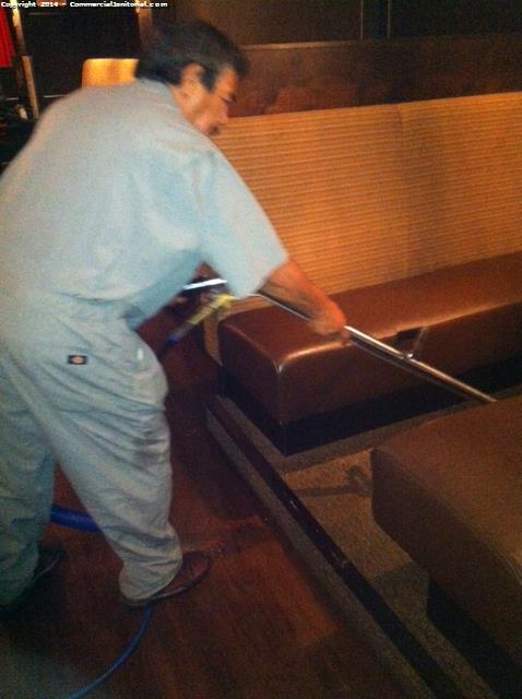 Using a portable unit with a wand to clean carpets when a truck mount is not available for extraction cleaning in a bar