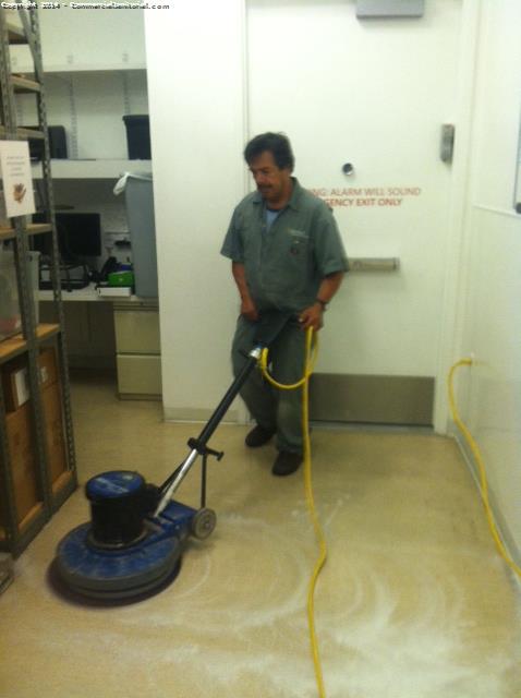 Floor tech scrubbing and recoating floor 