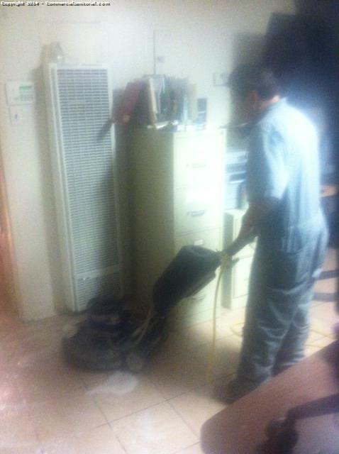 Cleaning the floors using a side by side a uniformed employee