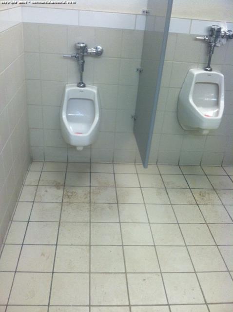 2 urinals with dirty floors before we clean